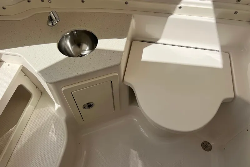  Yacht Photos Pics 2020 Robalo R302 Center Console boat interior with sink and storage compartment.