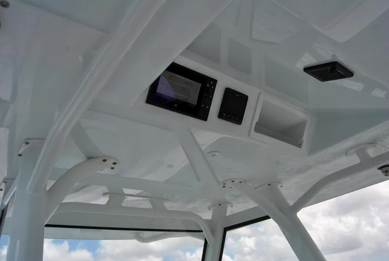  Yacht Photos Pics 2022 Yellowfin 39 Offshore boat interior with electronic controls and white framework.