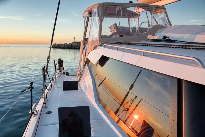 Cabalito De Mar Yacht Photos Pics 2024 Fountaine Pajot Catamaran Elba 45 at sunset, reflecting vibrant ocean view.