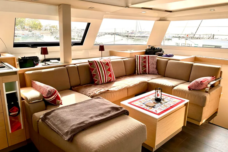 Cabalito De Mar Yacht Photos Pics Luxurious interior of 2024 Fountaine Pajot Catamaran Elba 45 with cozy seating and nautical decor.