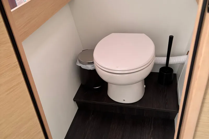 Cabalito De Mar Yacht Photos Pics 2024 Fountaine Pajot Catamaran Elba 45 bathroom with toilet and waste bin.