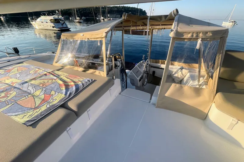 Cabalito De Mar Yacht Photos Pics 2024 Fountaine Pajot Catamaran Elba 45, spacious deck with sunbathing area and scenic marina view.