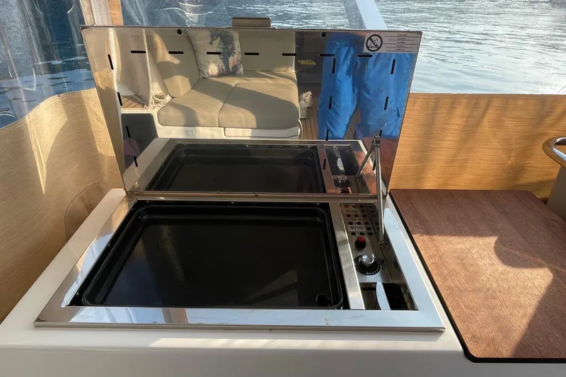 Cabalito De Mar Yacht Photos Pics Modern kitchen area on 2024 Fountaine Pajot Catamaran Elba 45 with stove and seating.