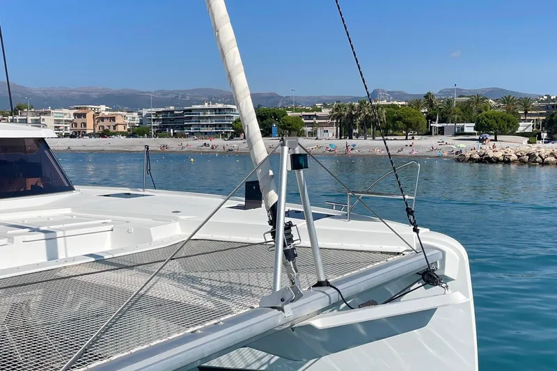 Cabalito De Mar Yacht Photos Pics 2024 Fountaine Pajot Catamaran Elba 45 docked near a scenic beach.