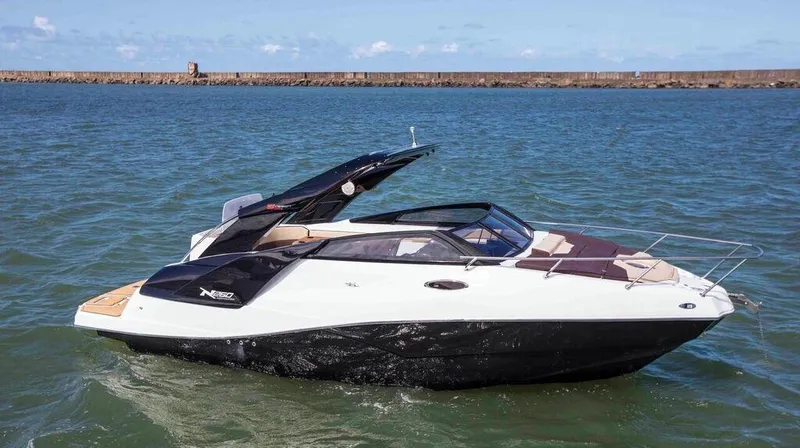  Yacht Photos Pics 2025 NX Boats NX260 EVOLUTION cruising on open water, showcasing sleek design and modern features.