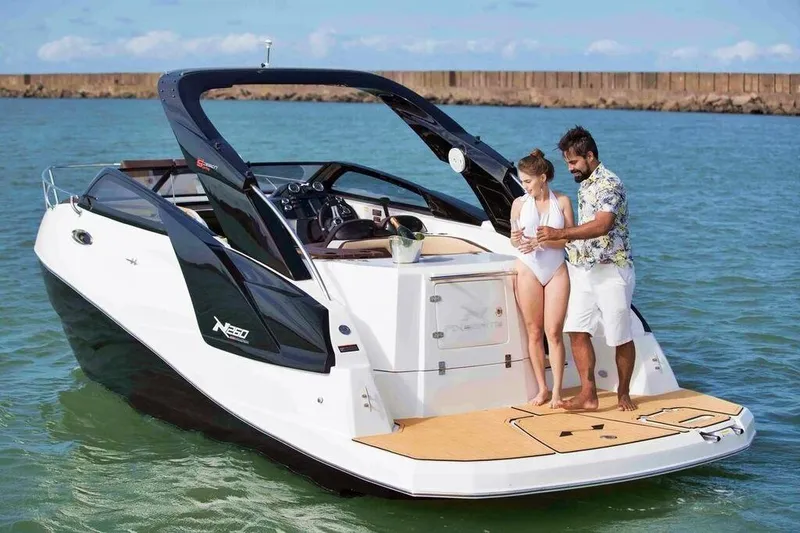  Yacht Photos Pics 2025 NX Boats NX260 EVOLUTION on water with two people enjoying the deck.