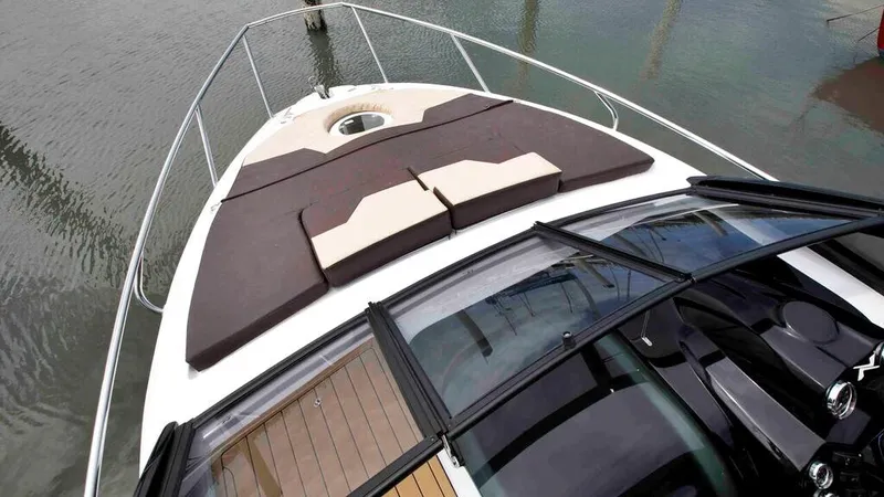  Yacht Photos Pics 2025 NX Boats NX260 EVOLUTION deck with cushioned seating, sleek design, and water view.