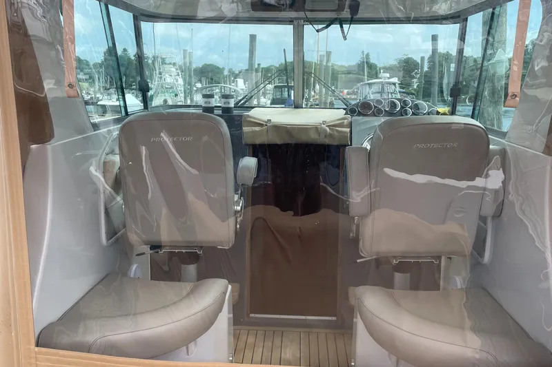  Yacht Photos Pics Interior view of 2018 Protector Tauranga 38 boat with two seats and a steering console.