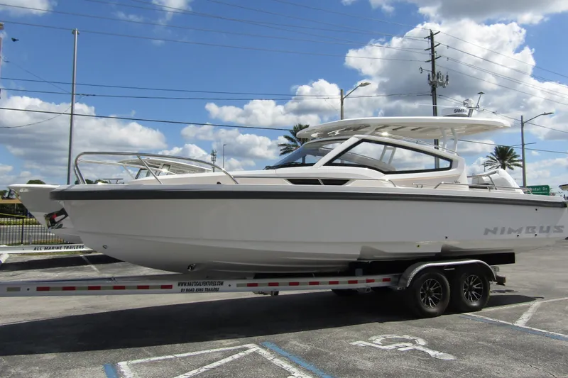  Yacht Photos Pics 2025 Nimbus Weekender 9 boat on trailer under blue sky.