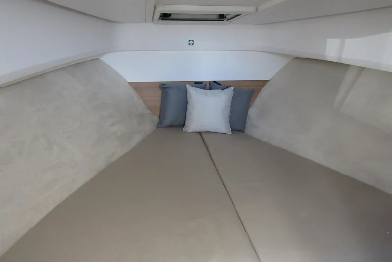  Yacht Photos Pics Interior cabin of 2025 Nimbus Weekender 9 with cushions and beige upholstery.