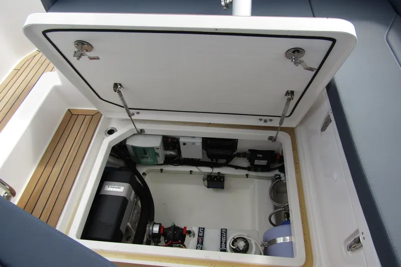  Yacht Photos Pics Open engine compartment of 2025 Nimbus Weekender 9 boat, showcasing mechanical components.
