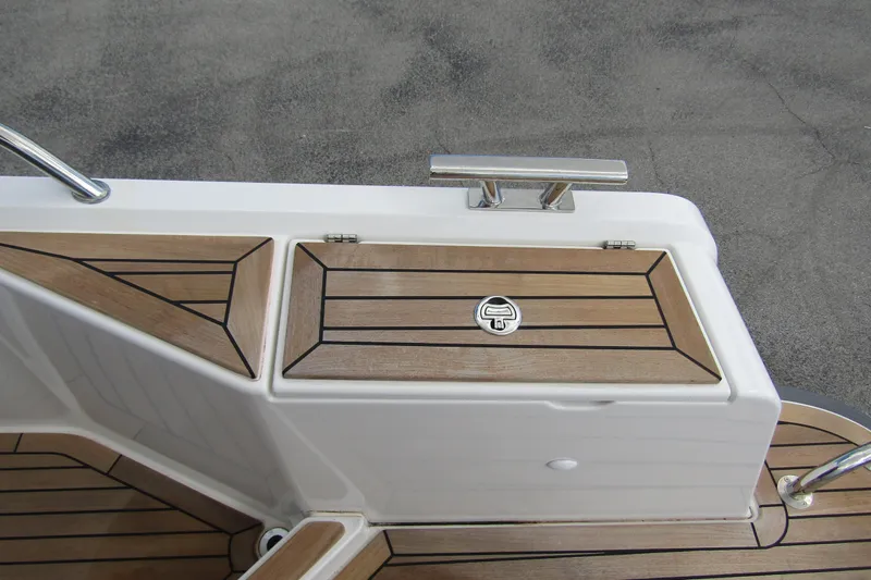  Yacht Photos Pics Teak deck detail on 2025 Nimbus Weekender 9 boat, featuring sleek design and stainless steel cleat.