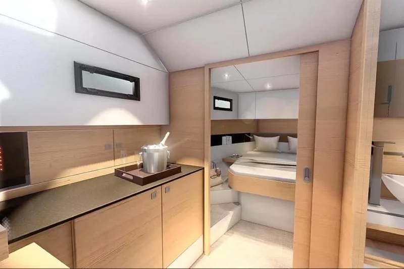  Yacht Photos Pics Luxurious interior of 2026 De Antonio Yachts D42, featuring modern bedroom and kitchenette.