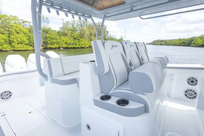  Yacht Photos Pics 2026 Yellowfin 42 Offshore boat interior with luxurious seating and scenic waterway backdrop.