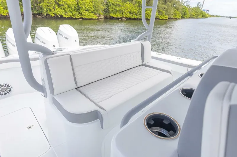  Yacht Photos Pics 2026 Yellowfin 42 Offshore boat with cushioned seating and Mercury engines on a calm waterway.