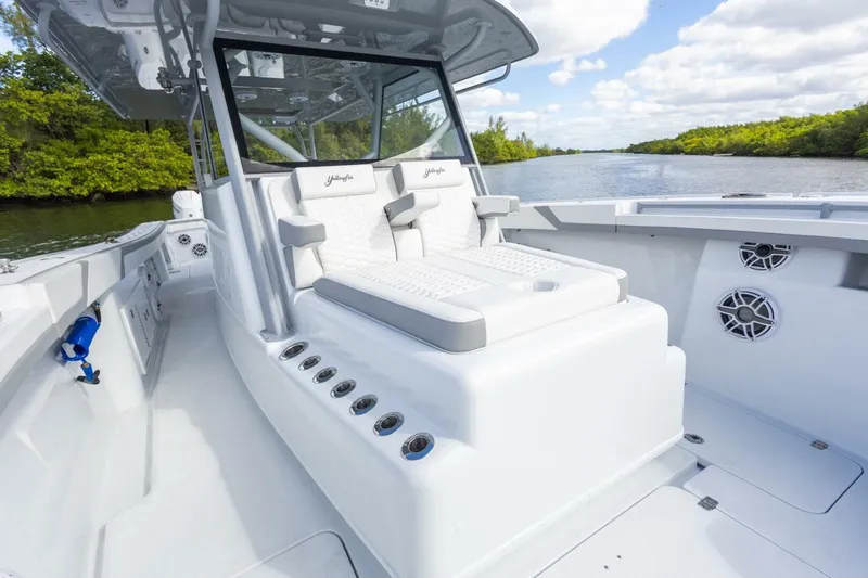  Yacht Photos Pics 2026 Yellowfin 42 Offshore boat interior with seating, on a scenic river.
