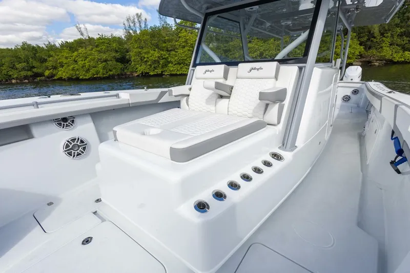  Yacht Photos Pics 2026 Yellowfin 42 Offshore boat interior with cushioned seating and sleek design.