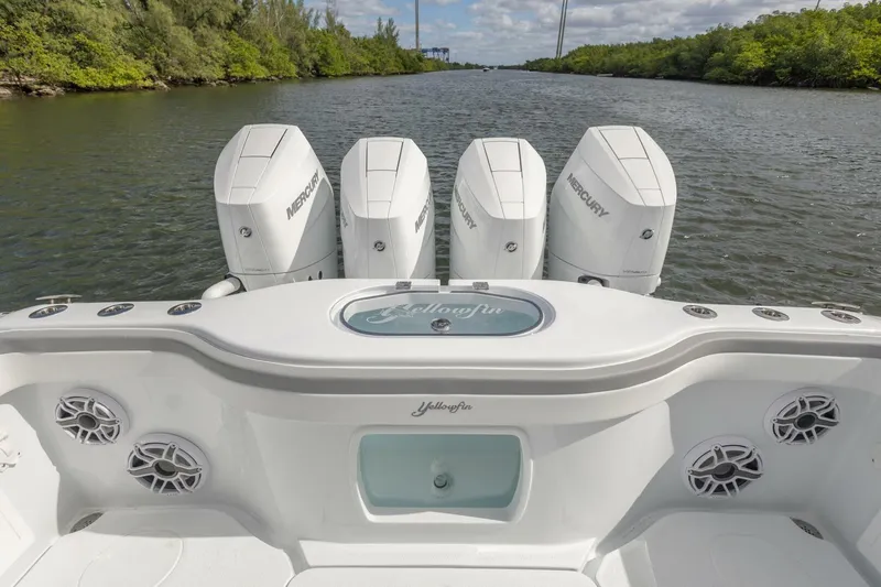 Yacht Photos Pics 2026 Yellowfin 42 Offshore boat with four Mercury engines on a scenic waterway.