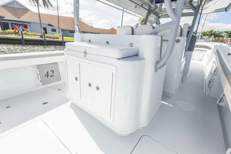  Yacht Photos Pics 2026 Yellowfin 42 Offshore boat interior with sleek white cabinetry and seating.