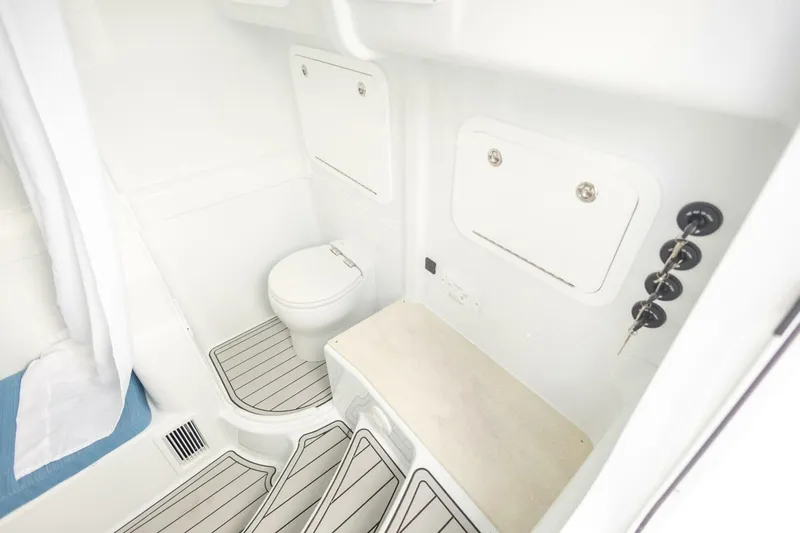  Yacht Photos Pics 2026 Yellowfin 42 Offshore boat bathroom with toilet and storage compartments.