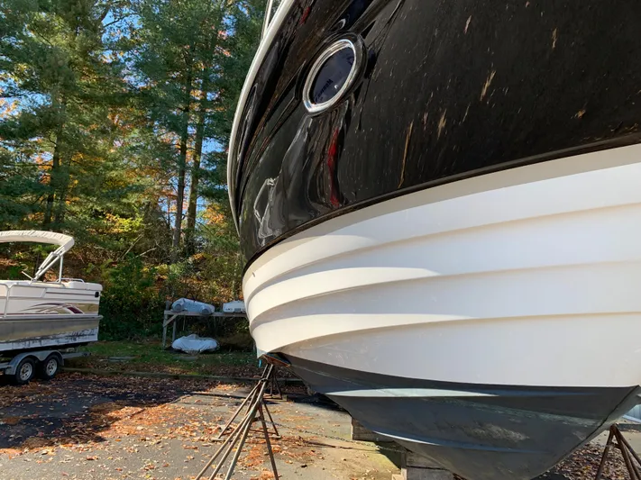  Yacht Photos Pics 2009 Regal 4460 boat on stands in a wooded area.