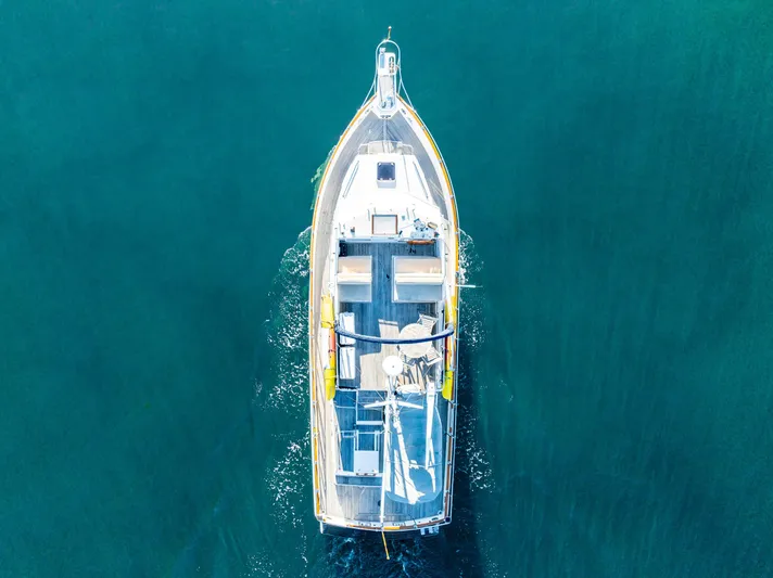 Voyageur Yacht Photos Pics Aerial view of 1995 Grand Banks Aft Cabin 42 Classic yacht cruising on clear blue water.