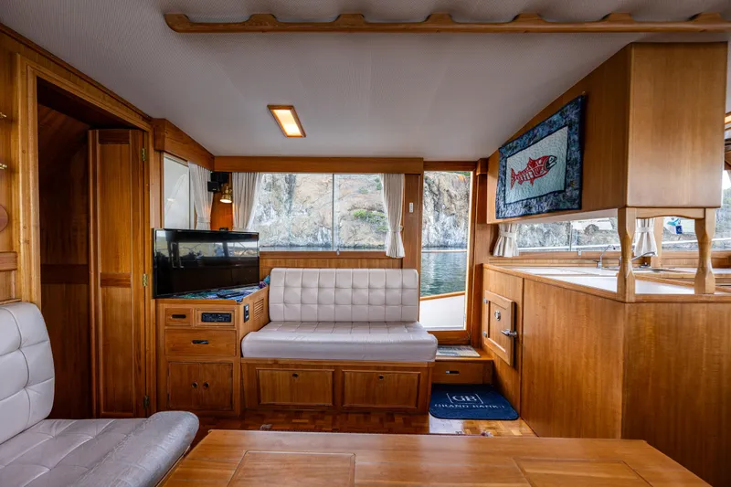 Voyageur Yacht Photos Pics 1995 Grand Banks Aft Cabin 42 Classic interior with wood finish and seating area.