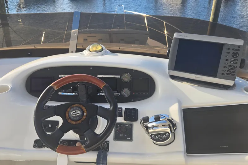 Solitude Yacht Photos Pics Cockpit of 1997 Sunseeker Manhattan 48 yacht with steering wheel and Garmin navigation system.
