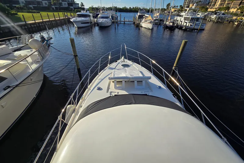 Solitude Yacht Photos Pics Sunseeker Manhattan 48 yacht docked at marina, 1997 model, surrounded by other boats.