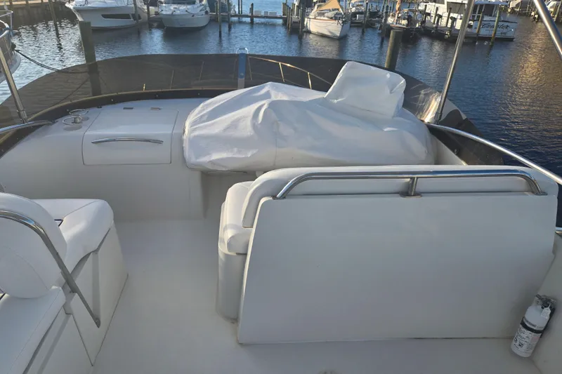 Solitude Yacht Photos Pics Sunseeker Manhattan 48 yacht interior, 1997 model, docked at marina with covered seating area.