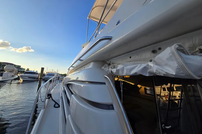 Solitude Yacht Photos Pics Sunseeker Manhattan 48 yacht docked at marina, showcasing sleek design and luxurious features.