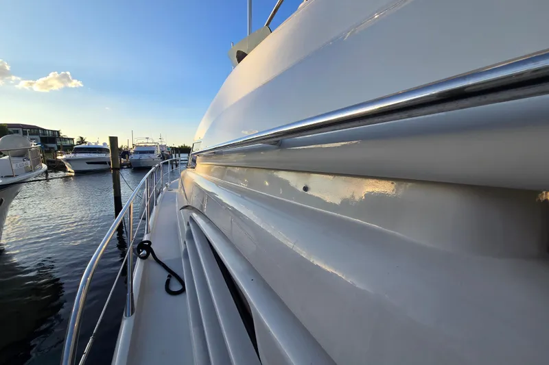 Solitude Yacht Photos Pics 1997 Sunseeker Manhattan 48 yacht docked at marina, side view at sunset.
