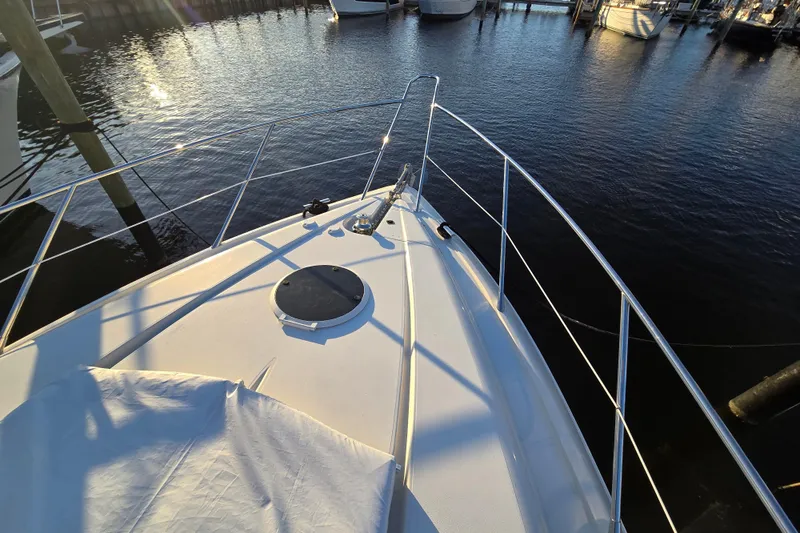Solitude Yacht Photos Pics Bow of 1997 Sunseeker Manhattan 48 yacht docked in marina at sunset.