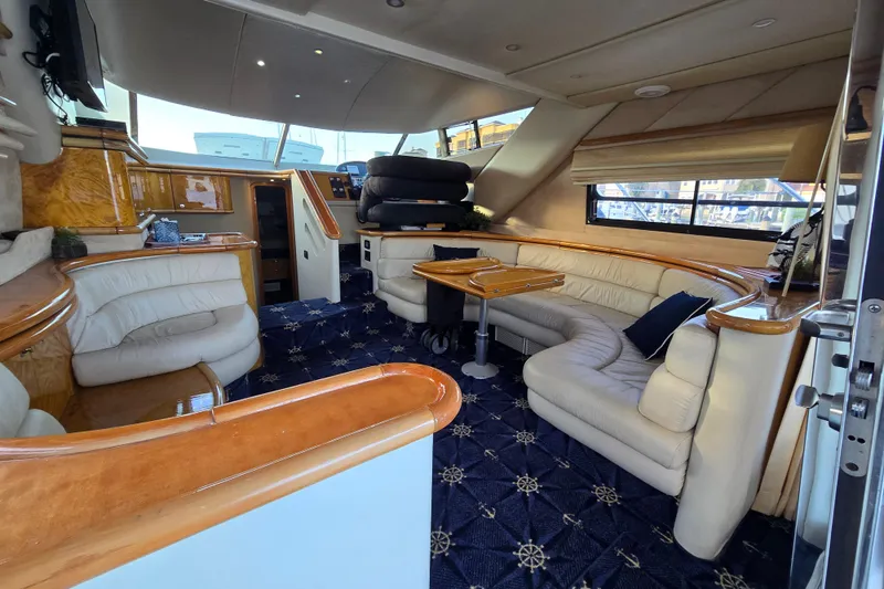 Solitude Yacht Photos Pics Luxurious interior of a 1997 Sunseeker Manhattan 48 yacht with elegant seating and wood accents.