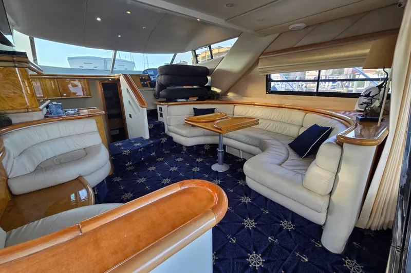 Solitude Yacht Photos Pics Luxurious interior of a 1997 Sunseeker Manhattan 48 yacht with elegant seating and wooden accents.