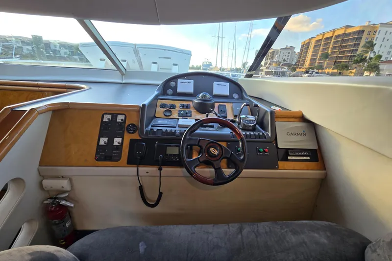 Solitude Yacht Photos Pics Interior helm of 1997 Sunseeker Manhattan 48 yacht with navigation controls and steering wheel.