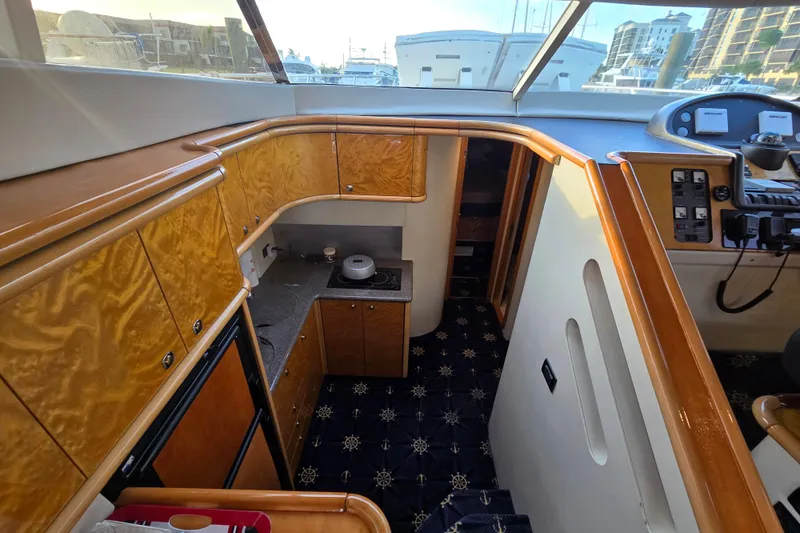Solitude Yacht Photos Pics Interior of 1997 Sunseeker Manhattan 48 yacht with wood cabinetry and modern amenities.