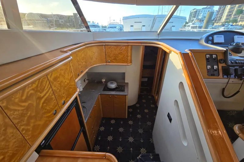 Solitude Yacht Photos Pics Interior of 1997 Sunseeker Manhattan 48 yacht, featuring wood cabinetry and modern controls.