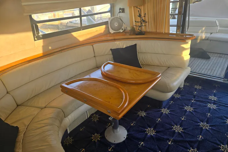 Solitude Yacht Photos Pics Luxurious interior of 1997 Sunseeker Manhattan 48 yacht with elegant seating and wooden table.