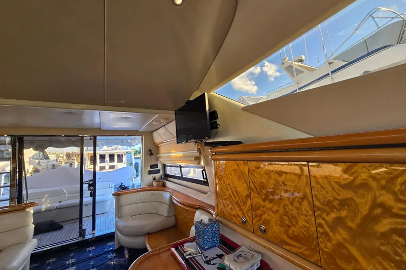 Solitude Yacht Photos Pics Interior of 1997 Sunseeker Manhattan 48 yacht, featuring luxurious seating and wood cabinetry.