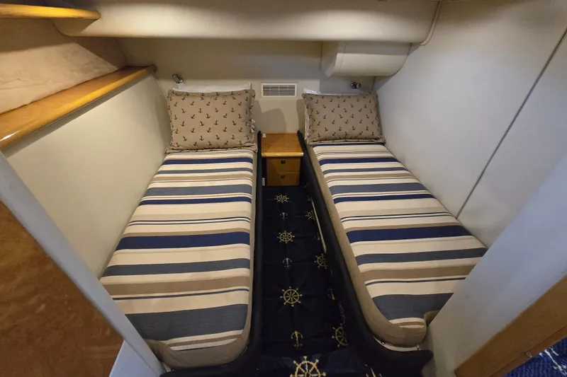 Solitude Yacht Photos Pics Twin cabin with striped bedding in 1997 Sunseeker Manhattan 48 yacht.