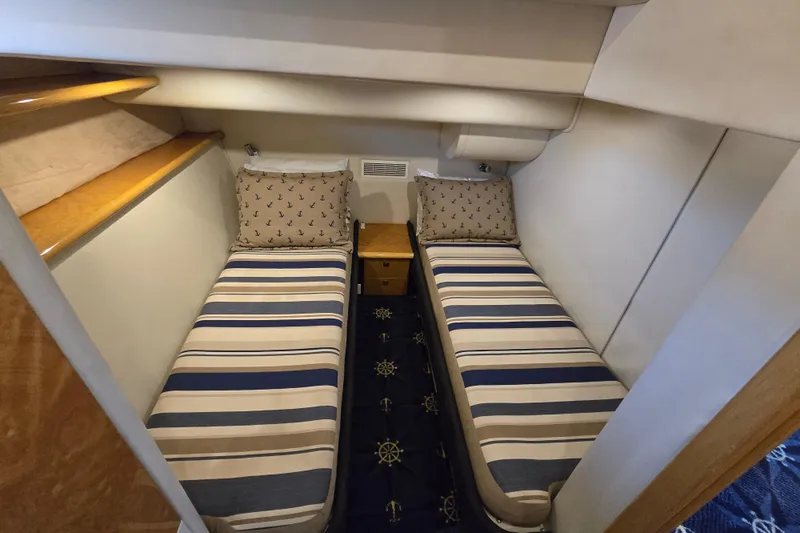 Solitude Yacht Photos Pics Twin cabin with striped bedding in 1997 Sunseeker Manhattan 48 yacht.