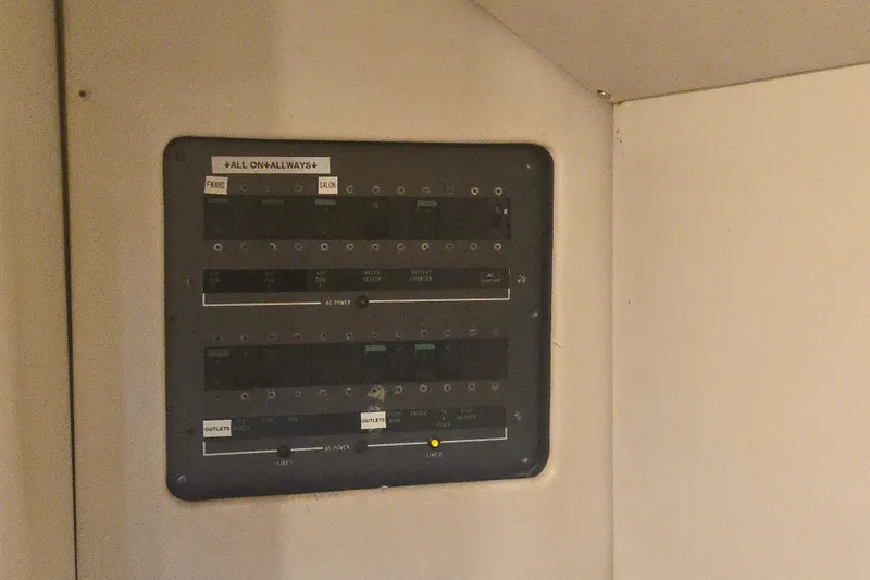 Solitude Yacht Photos Pics Electrical panel inside 1997 Sunseeker Manhattan 48 yacht, featuring labeled switches and controls.