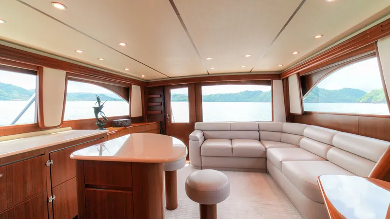Manudito Yacht Photos Pics Luxurious interior of a 2009 Viking 50C yacht with panoramic windows and modern furnishings.