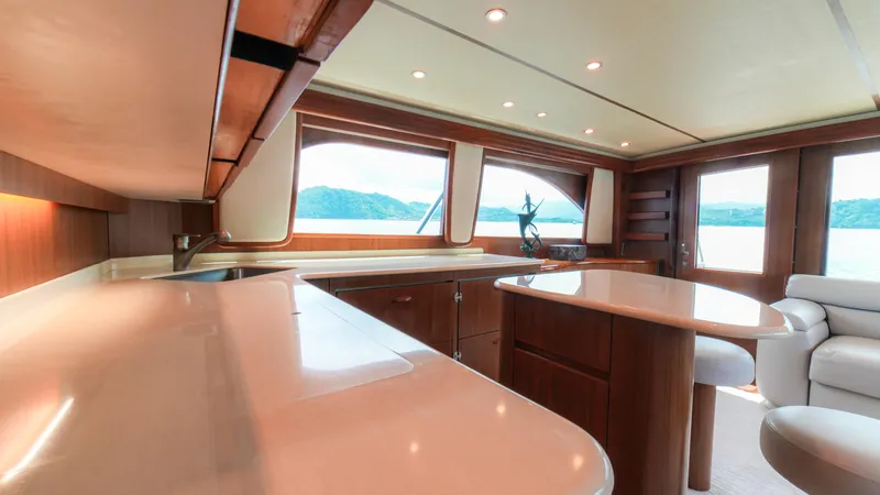 Manudito Yacht Photos Pics Luxurious interior of 2009 Viking 50C yacht with modern kitchen and scenic windows.