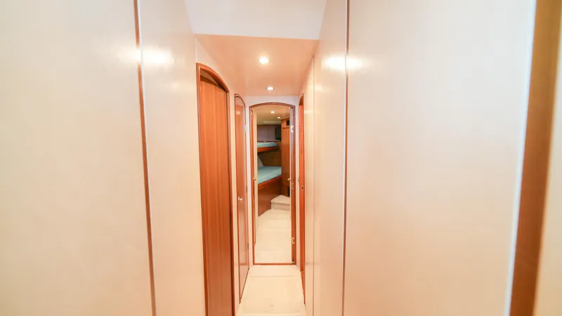 Manudito Yacht Photos Pics Narrow hallway inside 2009 Viking 50C yacht with wooden doors and recessed lighting.