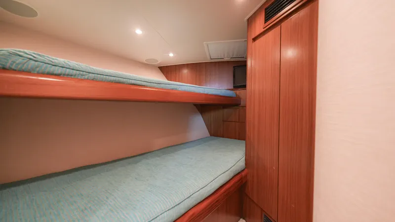 Manudito Yacht Photos Pics 2009 Viking 50C yacht interior with wooden bunk beds and teal bedding.