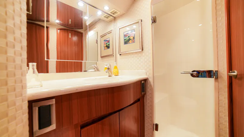 Manudito Yacht Photos Pics Luxurious bathroom in 2009 Viking 50C yacht with modern fixtures and wooden cabinetry.