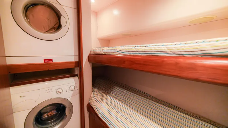 Manudito Yacht Photos Pics 2009 Viking 50C interior with bunk beds and washer-dryer unit.