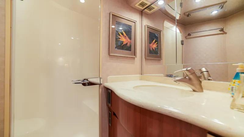 Manudito Yacht Photos Pics Luxurious bathroom in a 2009 Viking 50C yacht with modern fixtures and elegant decor.